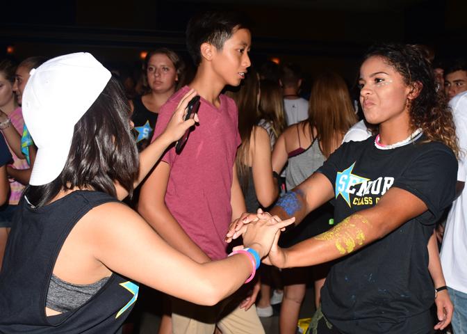 Holding hands, Sereyna Alvarez (12) dances with her friend as the DJ plays Bohemian Rhapsody by Queen.