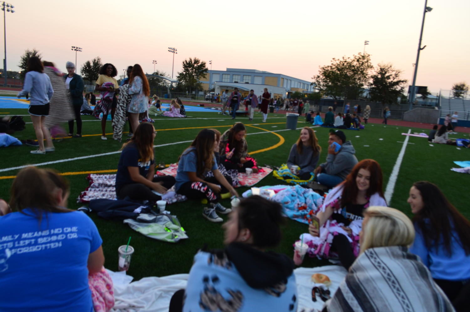 Seniors cuddle up in blankets as they watch the sunrise. 