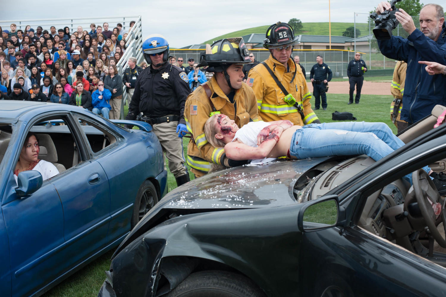 Students watch in terror as they see senior Lyndsey  Wernholm laying on the roof of a car.