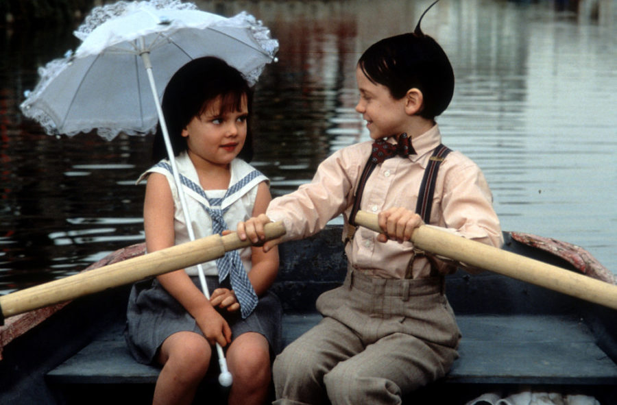 Bug Hall rowing a boat while looking at Brittany Ashton Holmes in a scene from the film The Little Rascals, 1994. (Photo by Universal Pictures/Getty Images)