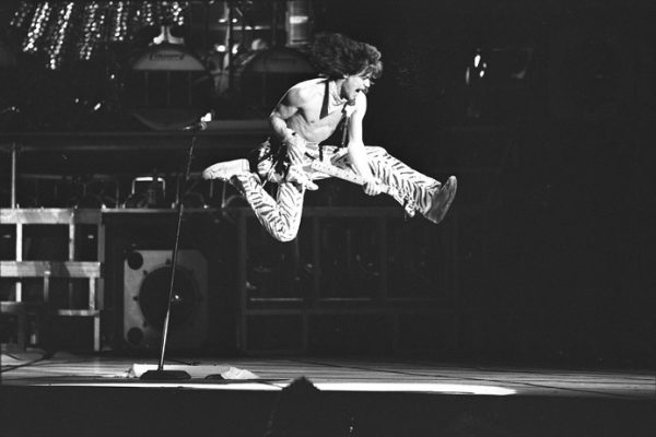 Los Angeles-based band Van Halen, guitarist Eddie Van Halen airborne during performance in Los Angeles, Calif., 1984 (22195741815) by UCLA Library Special Collections is licensed under CC BY 2.0.